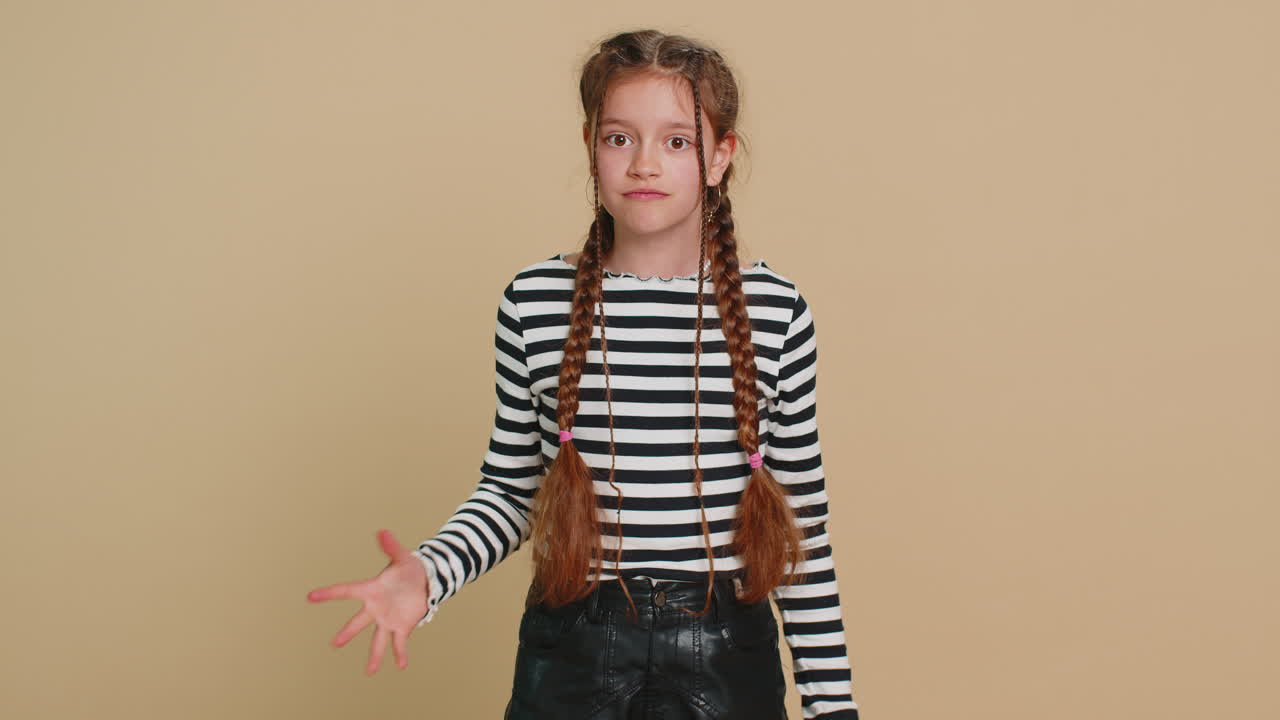 Displeased child girl gesturing hands with irritation blaming scolding for failure why this happened