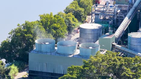 cooling fans operate amidst lush greenery in an industrial setting, highlighting environmental integration and efficient design