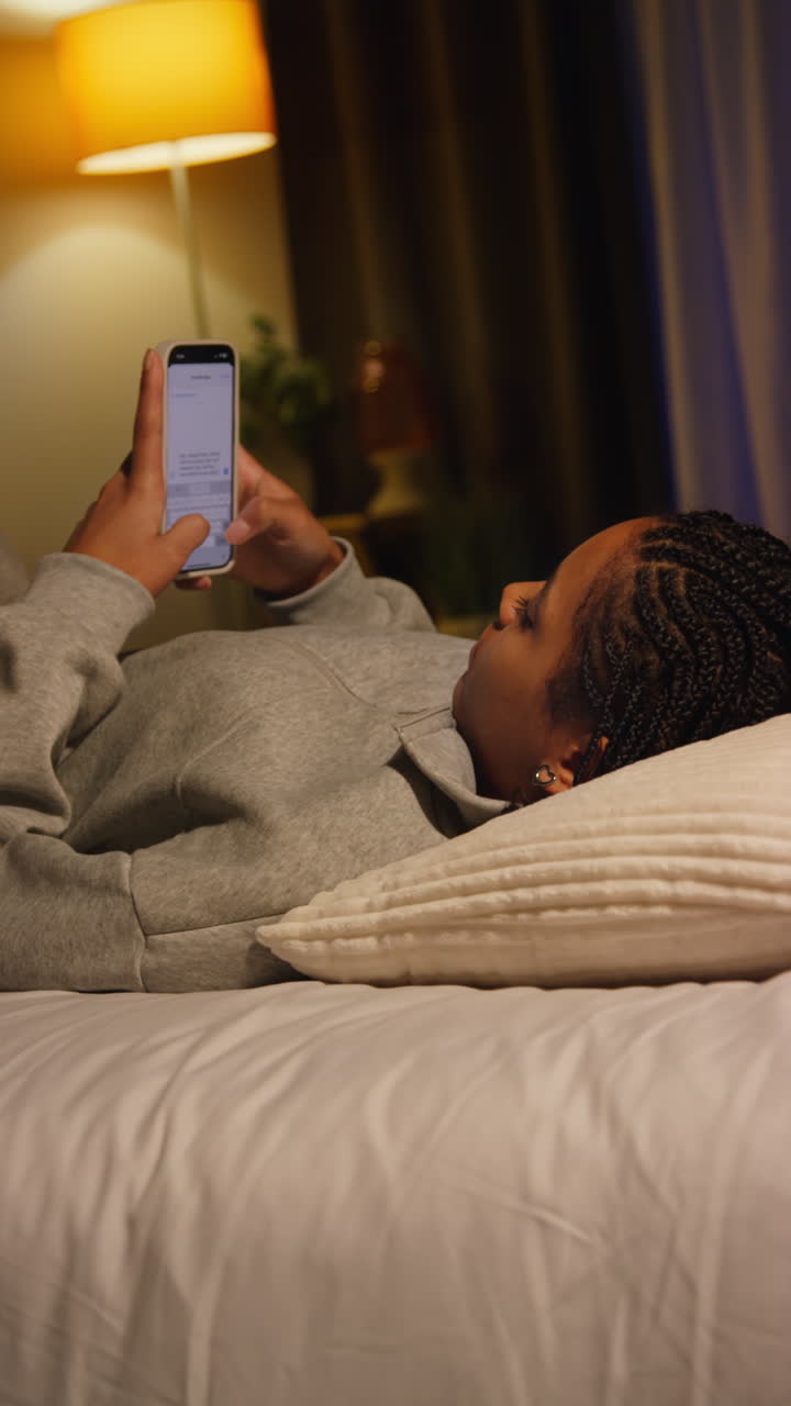 Woman Texting in Bed at Night
