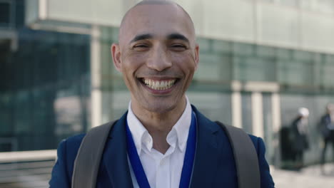 close up portrait of bald hispanic businessman looking laughing at camera corporate business