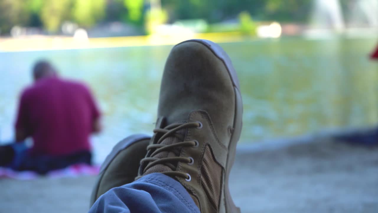 Resting feet on the sand different view