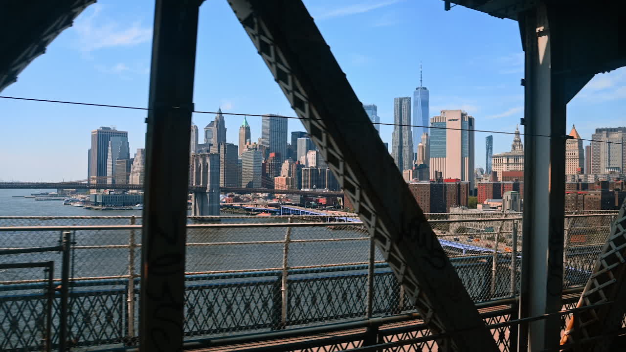 Footage from the train travelling by the Manhattan Bridge. Scenery of the Brooklyn Bridge and New York downtown