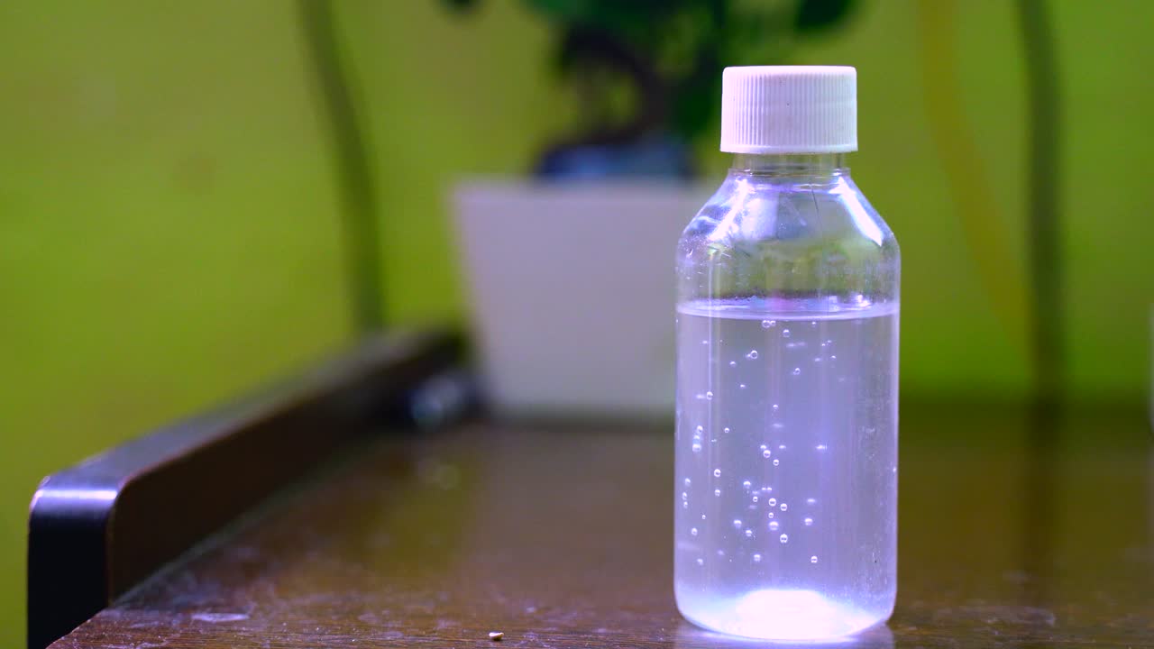 Coronavirus hand sanitizer sanitiser gel for clean hands hygiene corona virus spread prevention. Woman using alcohol rub alternative to washing hands.