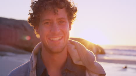 happy man on a beach at sunset