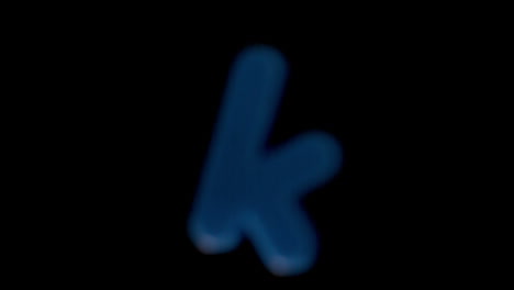 The-letter-k-coming-into-focus-on-black-background