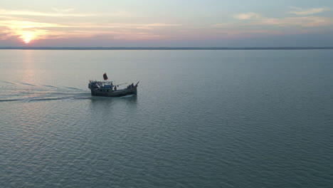 Aerial-Cinematic-Bangladesh-Sun-setting-in-the-river-and-boat-moving-Drone-Footage