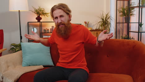 Bearded-ginger-man-asking-why,-what-reason-of-failure-demonstrating-disbelief-irritation-by-troubles