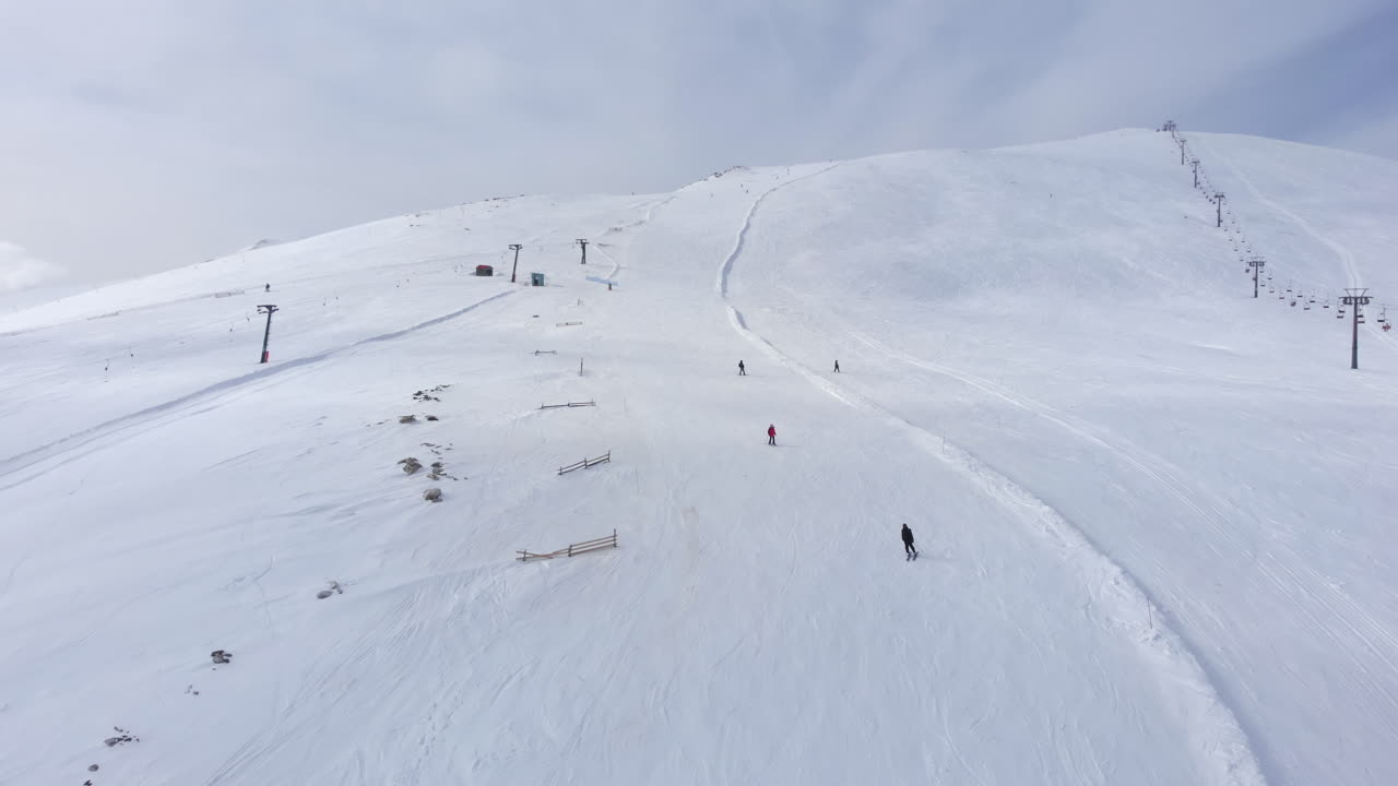 Drone view of skiers skiing downhill in the slopes in the scenic Mountain Kaimaktsalan Greece winter day