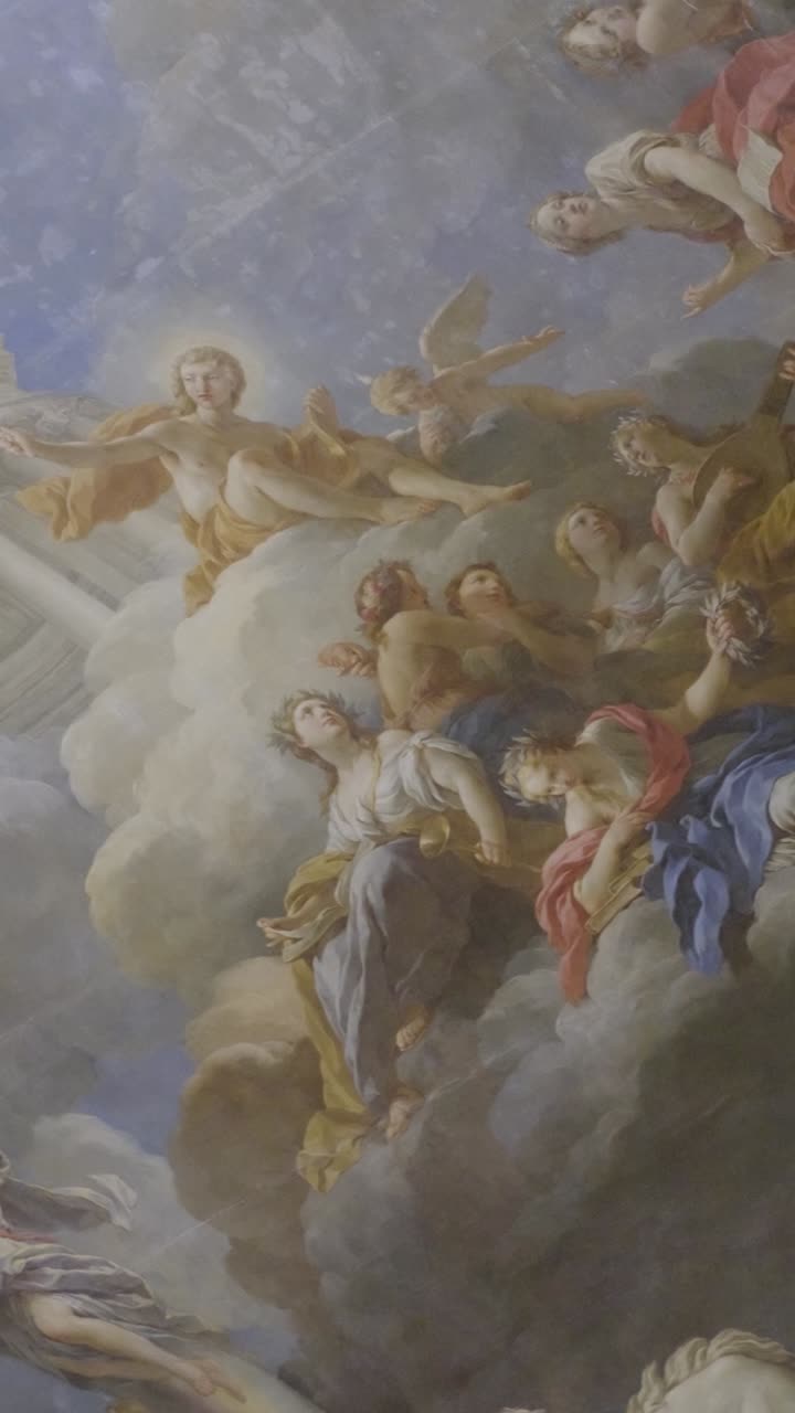 Ornate ceiling art in Versailles showing celestial figures and architecture