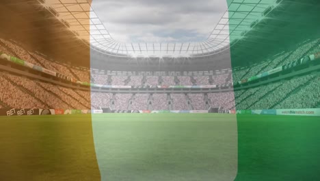 Animation-of-ivory-coast-flag-against-view-of-a-sports-stadium