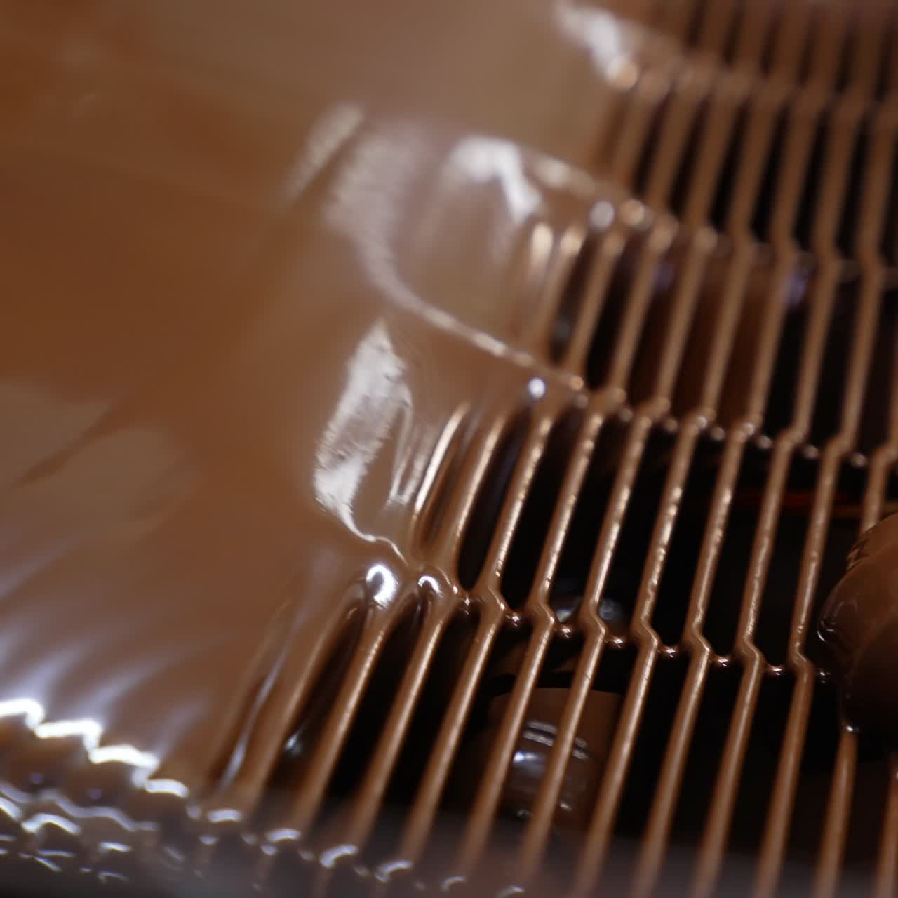 Chocolate covered sweets on a conveyor belt