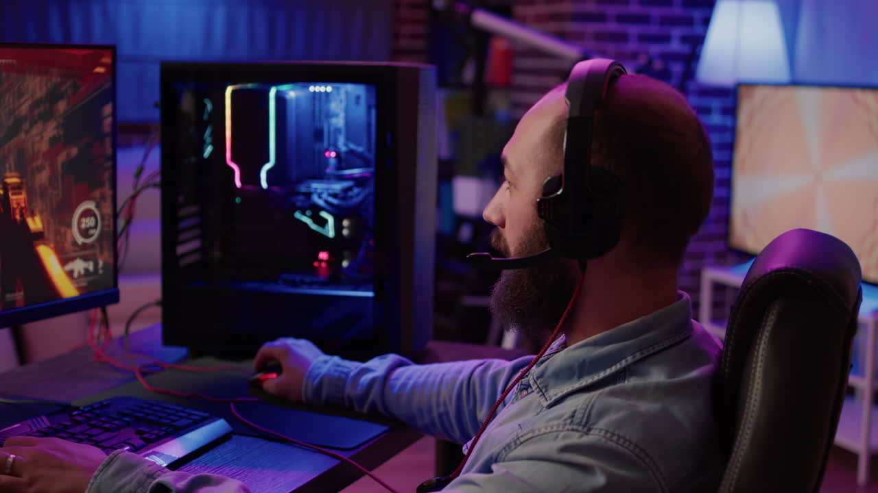 Extreme closeup of man using headset talking into microphone with team while playing first person shooter