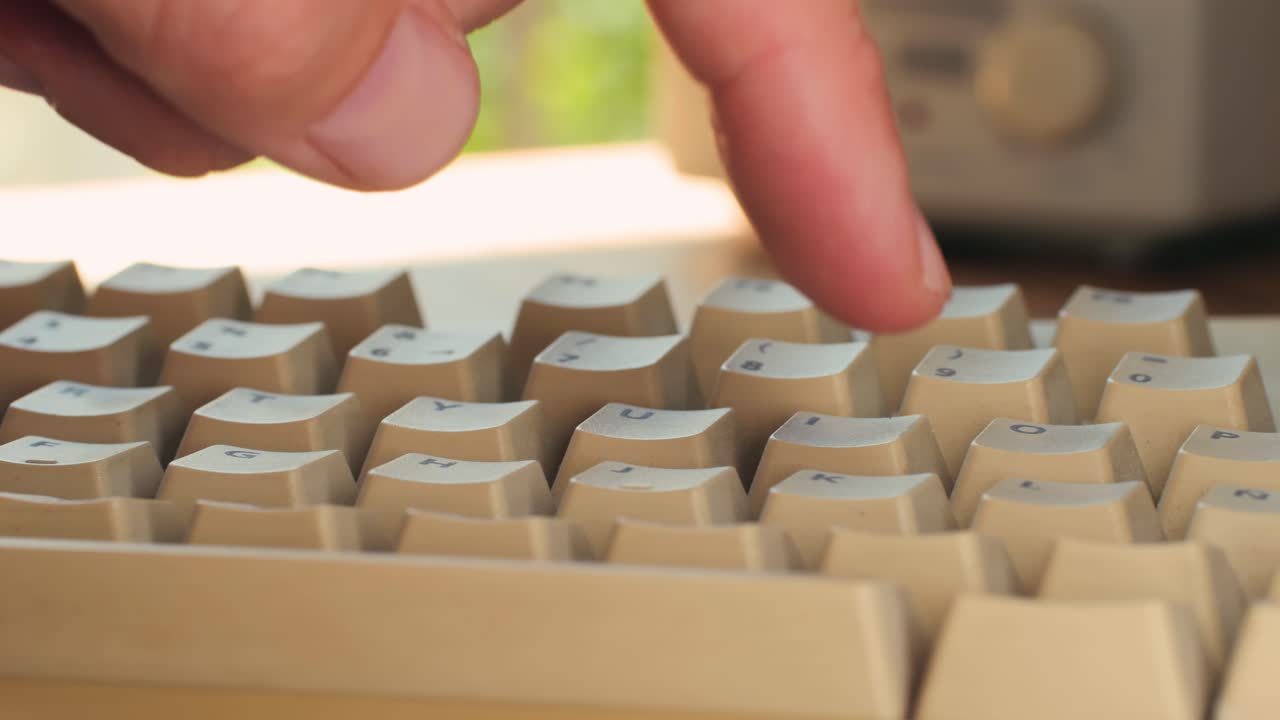 Man working and gaming on retro computer PC, IT engineer with vintage computer at home, using old fashion technology, close up of retro setup.