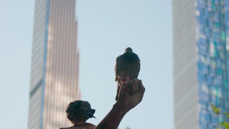 Pigeon-undisturbed,-coexisting-with-towering-human-architecture-of-city-backdrop