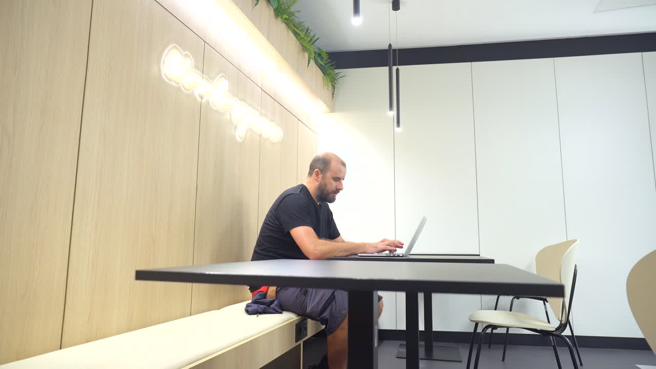 hombre trabajando en una computadora portátil en una oficina moderna