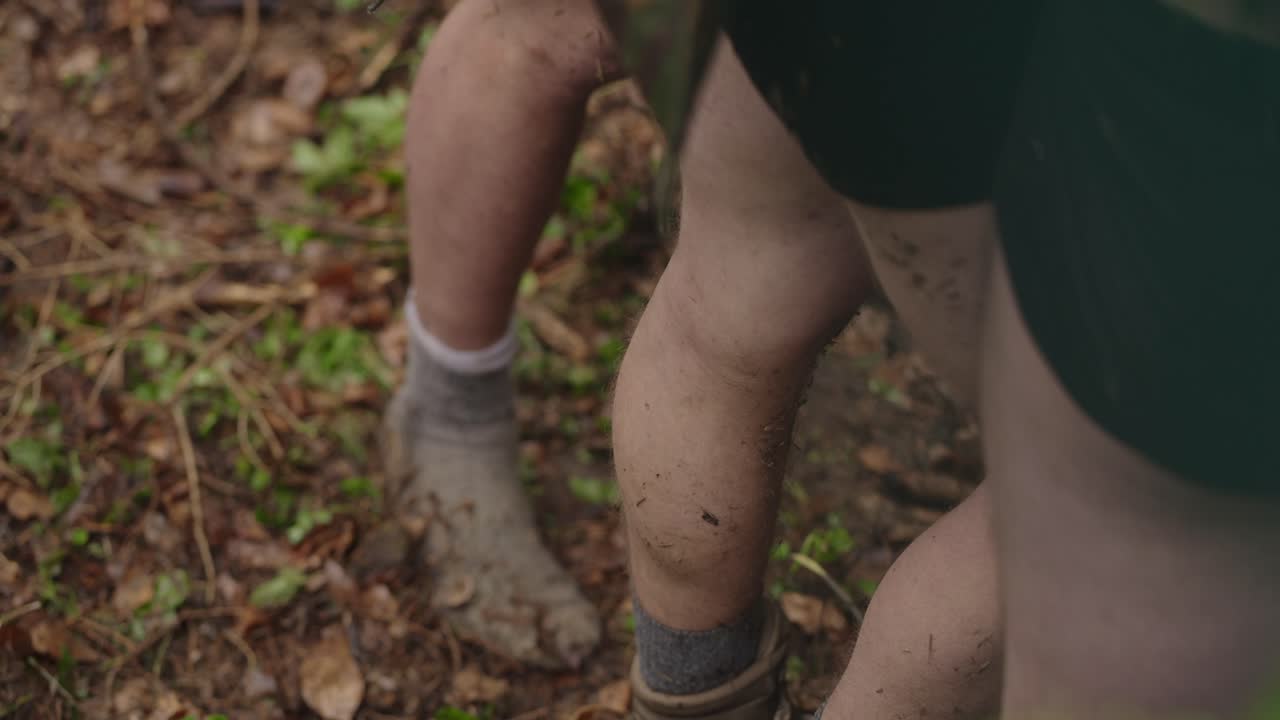 Mud-covered legs and socks outdoors, exploring nature, adventure vibes