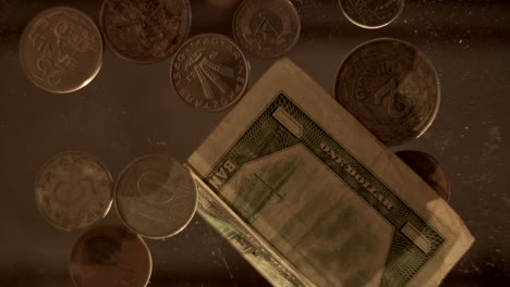 a close-up of vintage coins and a dollar bill being handled