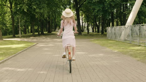 woman on a vintage bike in a park