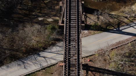 top down aerial shot moving forward along the pope lick railroad trestle in louisville kentucky during the winter