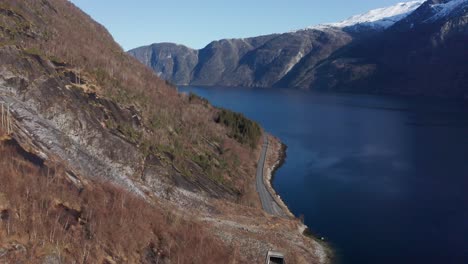 Tunnel-going-straight-through-a-landslide-in-Eidfjord-Norway---Beautiful-mountain-scenery-with-fjord-in-background---Norway