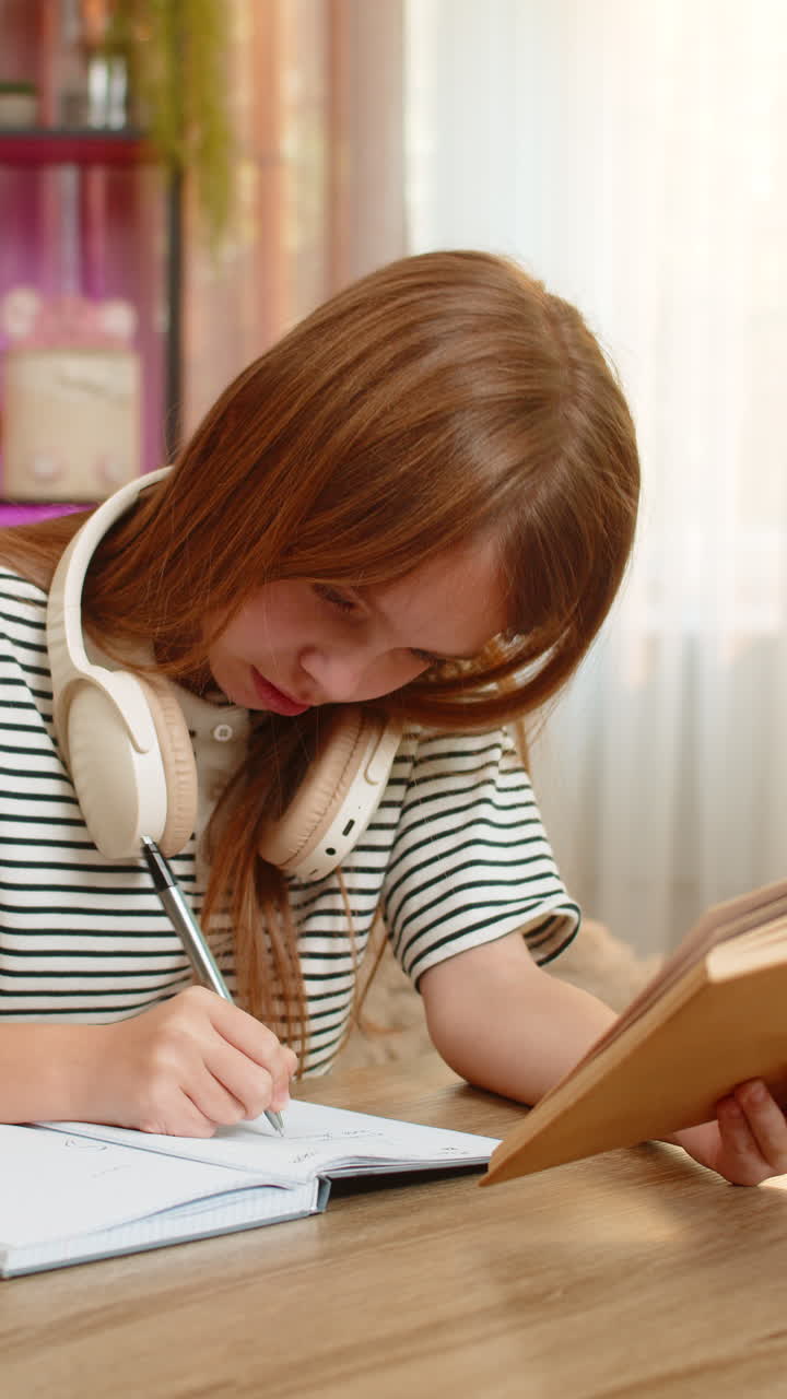 Child girl kid confused by school textbook task at table on home sofa holding head with frustration