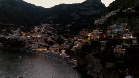 aerial: beautiful panoramic shot of positano in amalfi coast of italy during dusk