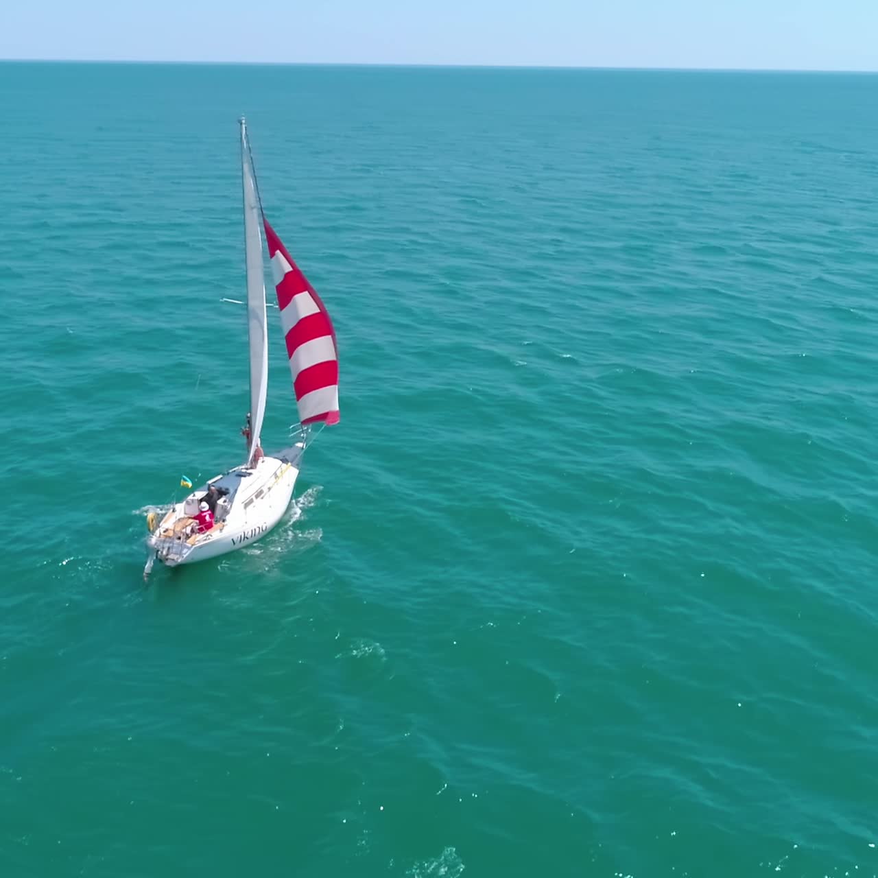 Luxury ship at open sea. Seascape with sails yacht in open sea, aerial view