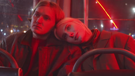 young couple riding tram in night