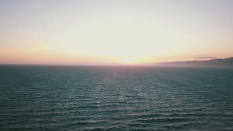 drone shot of sunset over pacific ocean at venice beach los angeles