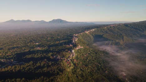 aerial view overlooking the kintamani village, misty morning in bali, indonesia