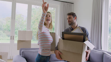 couple holding cardboard boxes and interacting with each other in new home 4k