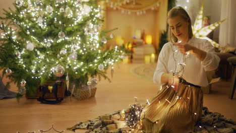 preparing for christmas woman organizes christmas lights