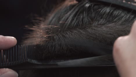 professional haircut with scissors and comb