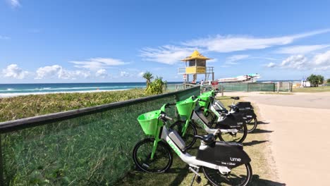 row of green bikes near lifeguard tower