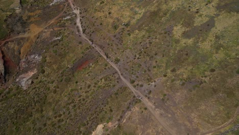 Aerial-view-looking-down-over-tourists-trekking-Ponta-de-sao-Lourenco-scenic-hiking-wilderness-path