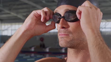 swimmer putting his pool goggles