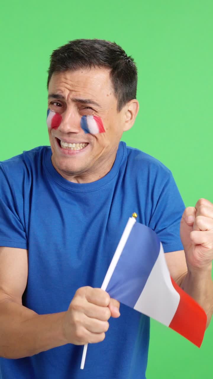 Nervous french supporter during an exciting match looking away