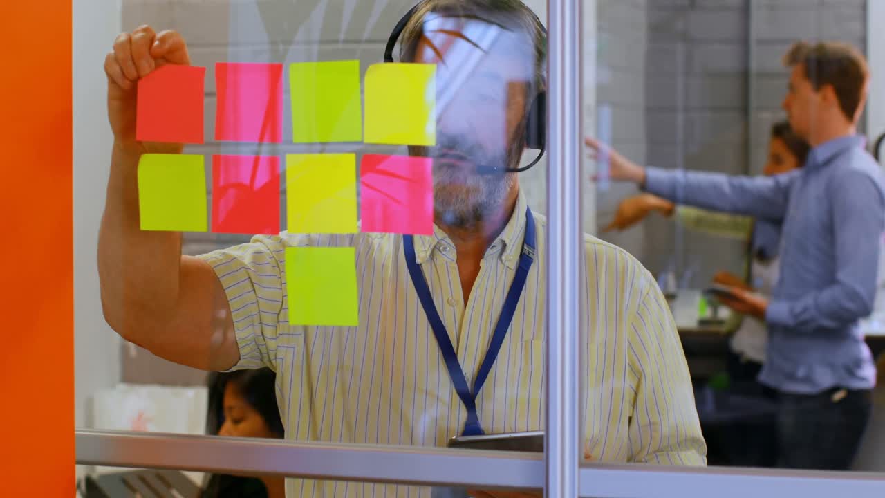 Male executive talking on headset while using digital tablet 4k