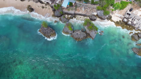 Rock-Islands-Off-Bingin-Beach-Cliffs-Uluwatu-Indonesia-Pan-Up