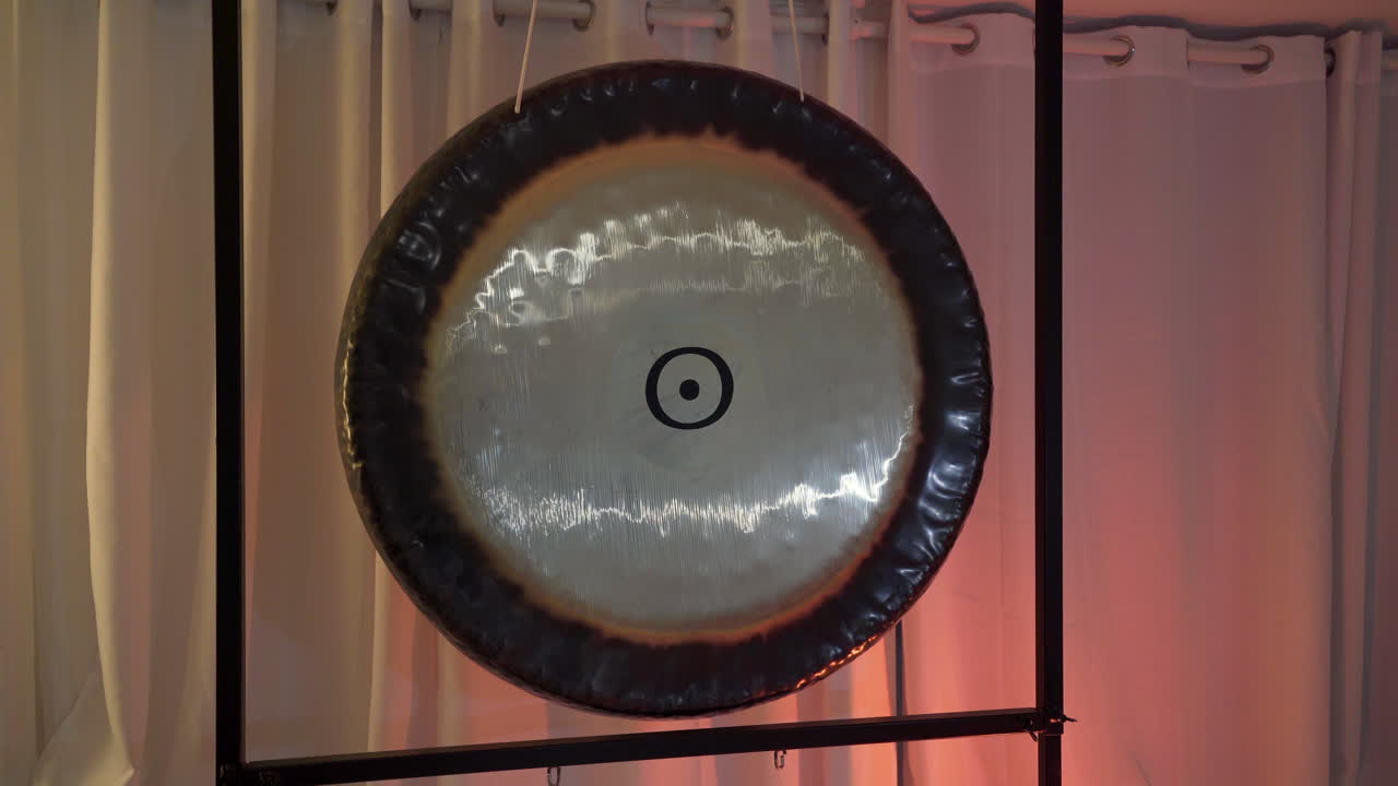 Copper gong musical instrument hanging on a frame in meditation room