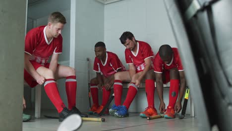 hockey players putting on their equipment