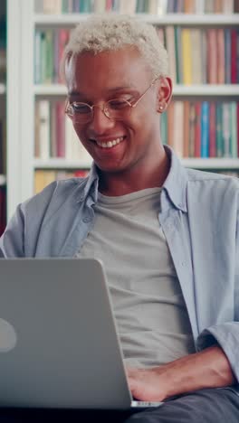 young laughing positive african american man millennial watches comedy on laptop