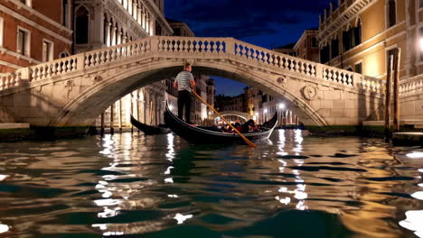 Gondola Ride Under a Bridge in Venice at Night