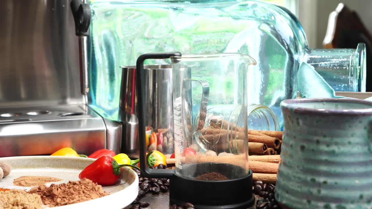 Cup or mug of coffee in a blue ceramic cup with whipped cream and a dash of nutmeg or cinnamon. Coffee beans surrounding a cozy cup of coffee in a blue mug.