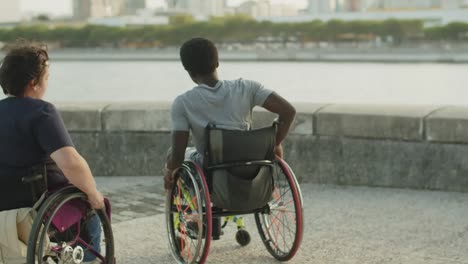 happy couple dancing and spinning on wheelchairs