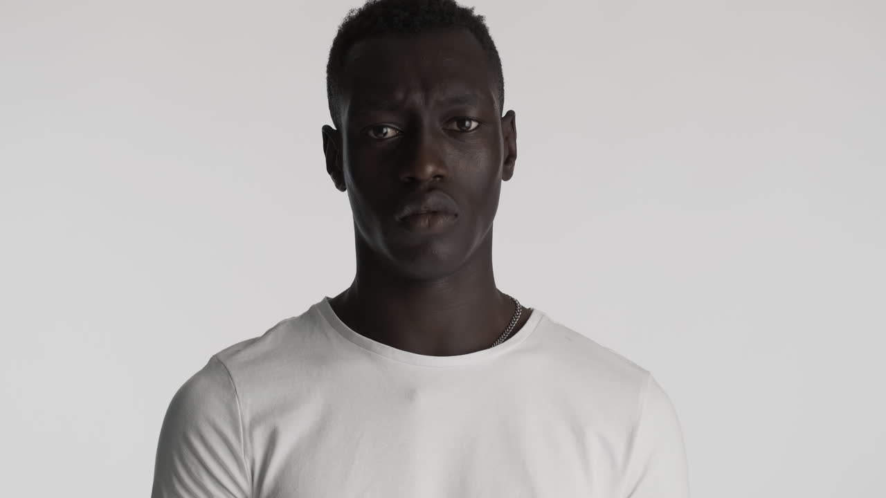 Serious African american man on grey background.