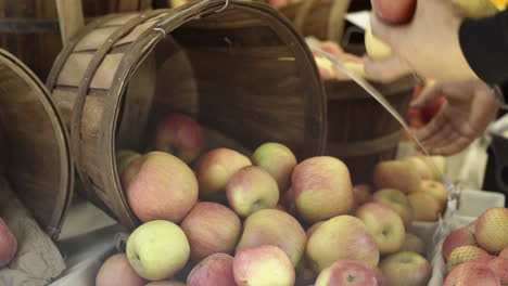 fresh apples spilling from a basket at a market