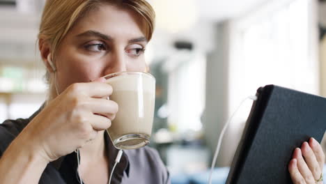 Hermosa-Mujer-Usando-La-Pantalla-Táctil-De-La-Tableta-IPad-En-La-Cafetería