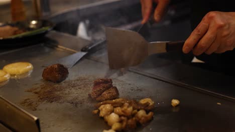 chef cooking meat and vegetables on hot grill