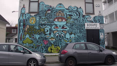 panning shot of colourful mural artwork on the side of a house on sundgata at haugesund